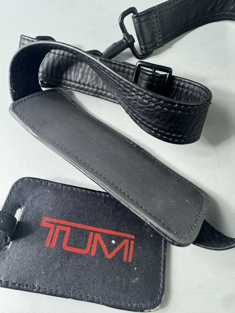 A Bundle of Two (2) Vintage Tumi Black Leather Strap and Travel Tag